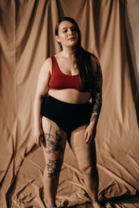 Plus size woman with tattoo on her stretch marks.