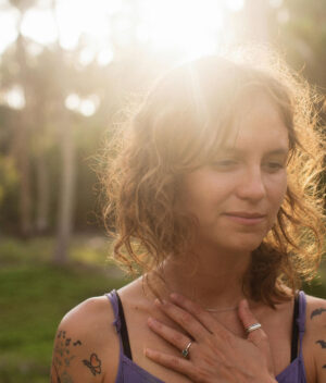 An newly inked woman basking under the sun. This is for the post: Can You Put Sunscreen on a New Tattoo?