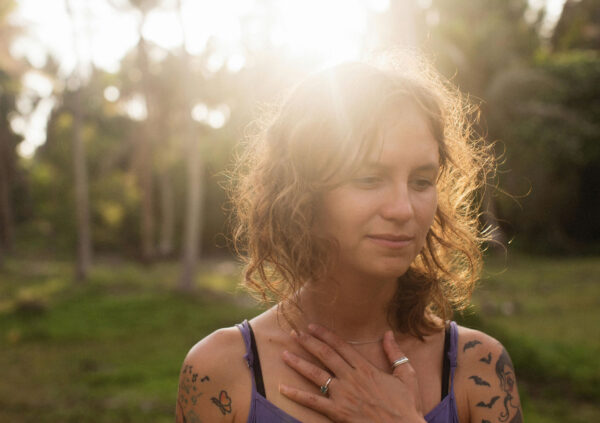 An newly inked woman basking under the sun. This is for the post: Can You Put Sunscreen on a New Tattoo?