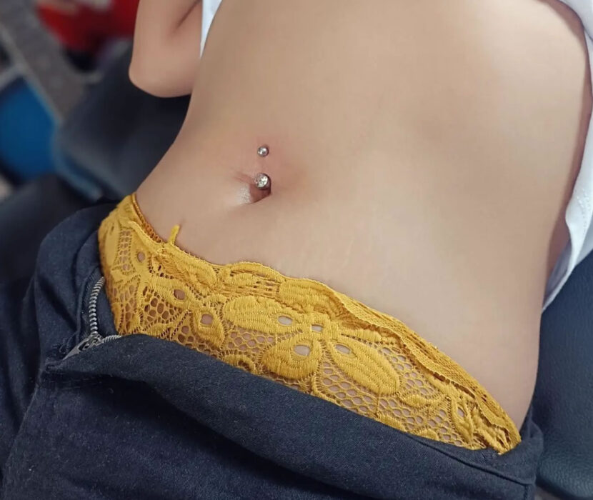 Woman client with her new navel piercing from Irie Pierching Siargao studio.