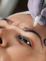 Woman client being prepared for permanent cosmetics procedure.